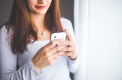 close-up-portrait-of-a-young-woman-typing-a-text-message-on-6400