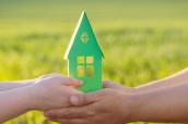 stock-photo-paper-house-in-hand-outdoor