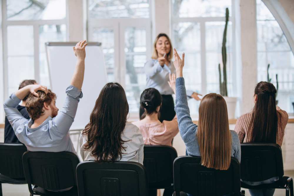 female-speaker-giving-presentation-hall-university-workshop-audience-conference-hall-1